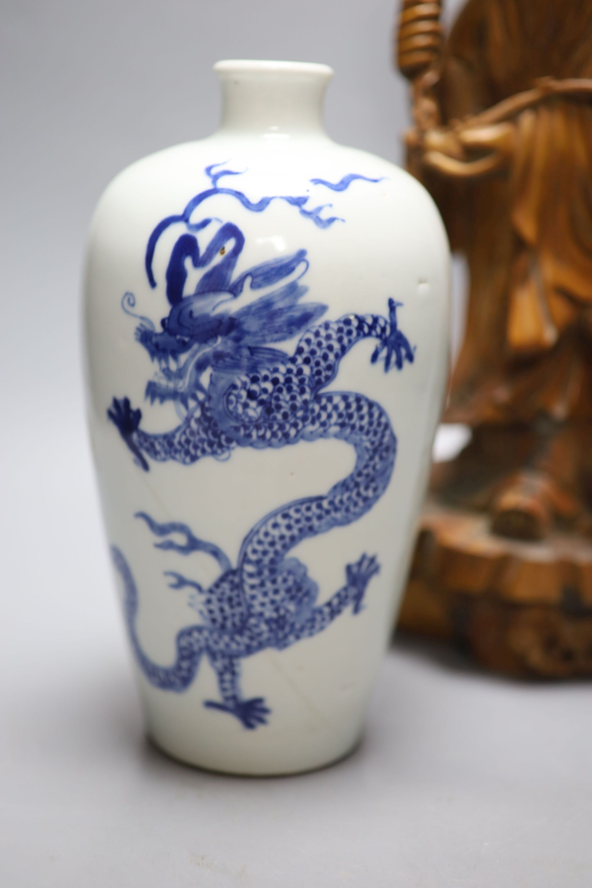 A pair of Satsuma bottle vases, a Chinese blue and white dragon vase, 22cm, and a hardwood carving of Shou Lao, height 37cm